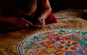 Lamayouro, Leh district, India. July 2017. Tibetian monks constructing mandala from colored sand in Tibetan Buddhist monastery. Sand mandalas transmit positive energies to the people who view them.